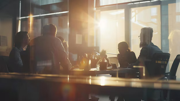 Warm meeting around a table with sunlight through windows